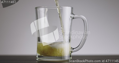 Image of Pouring beer into big mug until its full timelapse footage