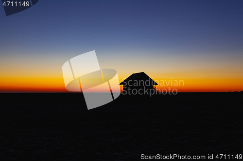 Image of Old barn on the field at sunrise