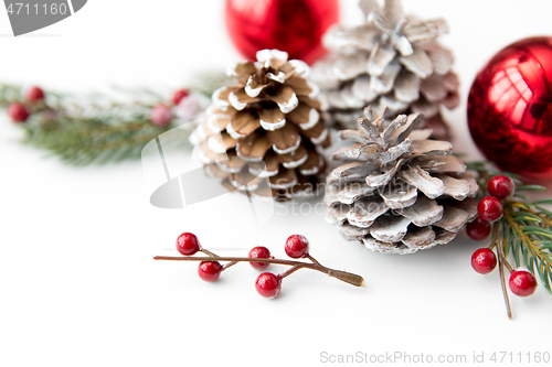 Image of christmas balls and fir branches with pine cones