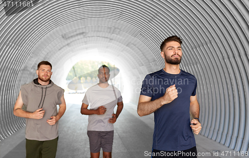 Image of young men or male friends running outdoors