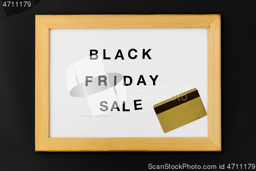 Image of board with black friday sale words and credit card