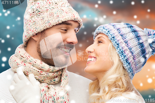 Image of smiling couple in winter clothes hugging