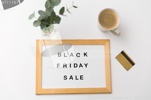 Image of board with black friday sale words and credit card