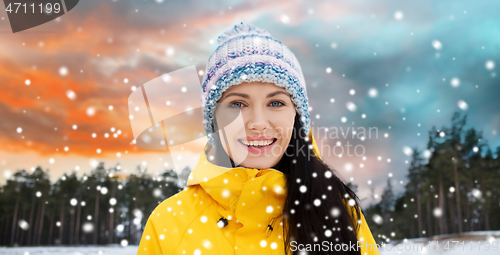 Image of happy young woman in winter clothes outdoors