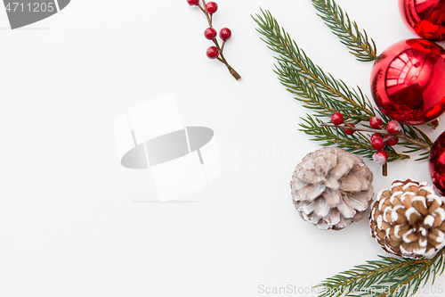 Image of christmas balls and fir branches with pine cones
