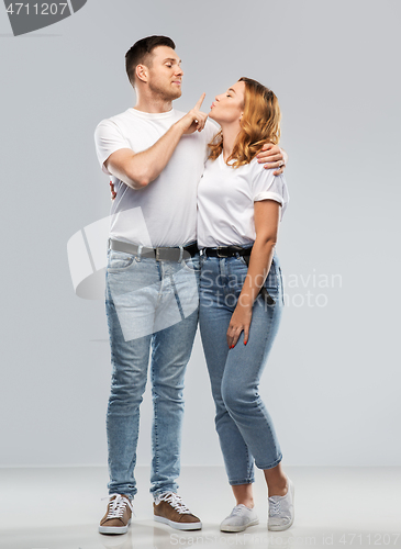 Image of couple in white t-shirts ready for kiss