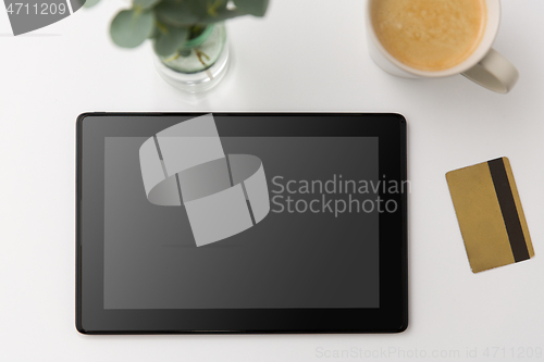 Image of tablet pc computer, credit card and cup of coffee