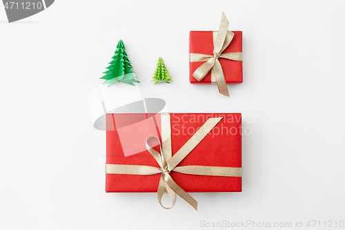 Image of gift boxes and christmas trees on white background