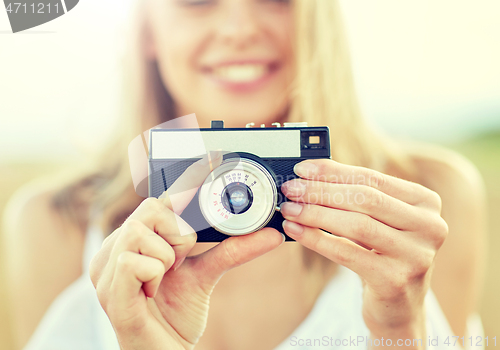 Image of close up of woman photographing with film camera