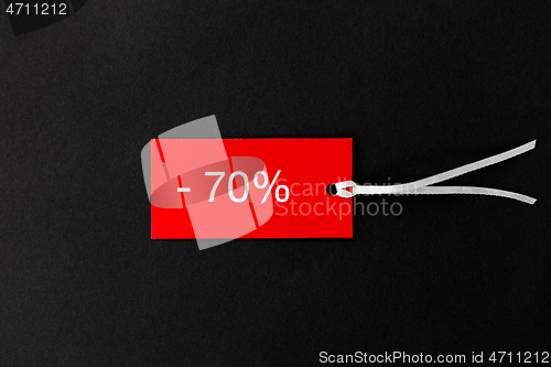 Image of red tags with discount signs on black background