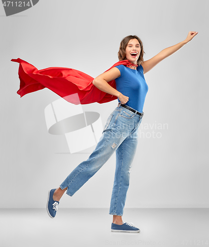 Image of happy woman in red superhero cape