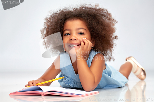 Image of happy little african american girl with sketchbook