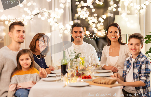 Image of happy family having dinner party at home