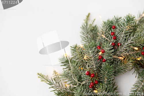 Image of christmas fir wreath with berries and lights