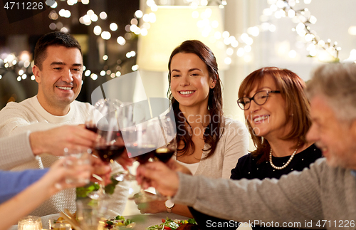 Image of happy family having dinner party at home