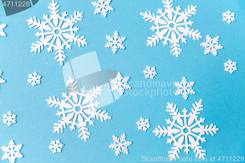 Image of white snowflake decorations on blue background