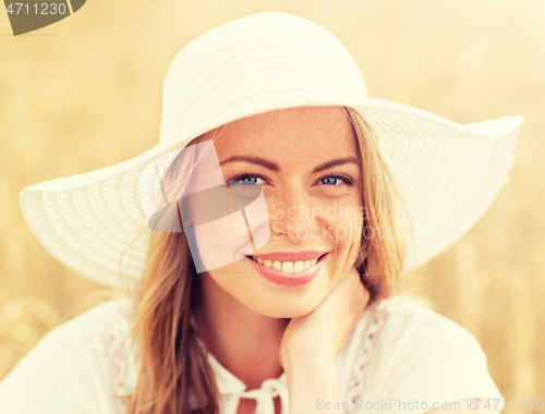 Image of close up of happy woman in sun hat on cereal field