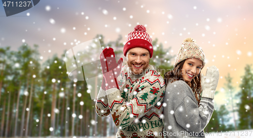 Image of couple in christmas ugly sweaters in winter