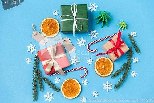 Image of christmas gifts, branches, tags and decorations