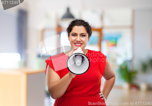 Image of happy woman in red dress speaking to megaphone