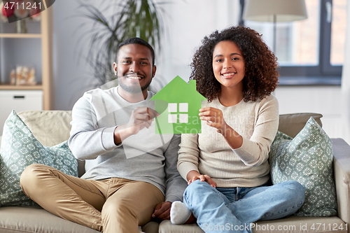 Image of happy african american couple on sofa at home