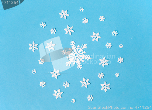 Image of white snowflake decorations on blue background