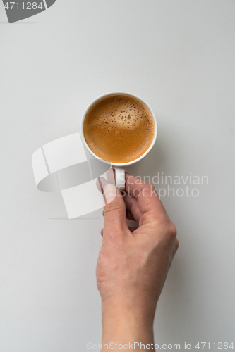 Image of Man holding cup of coffee