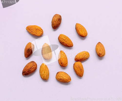 Image of almonds on light purple background