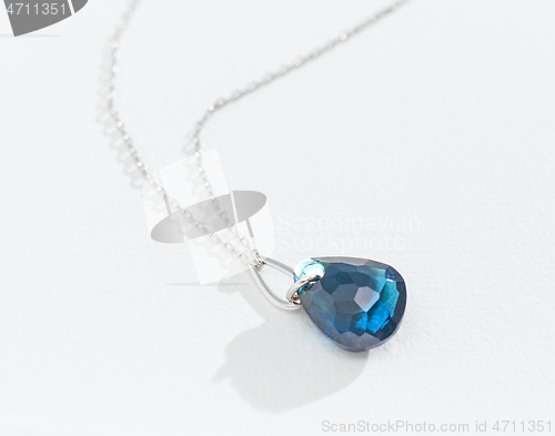 Image of silver chain with blue gemstone