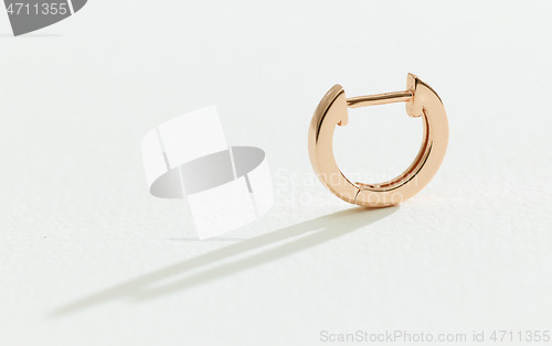 Image of gold earring on a white background 
