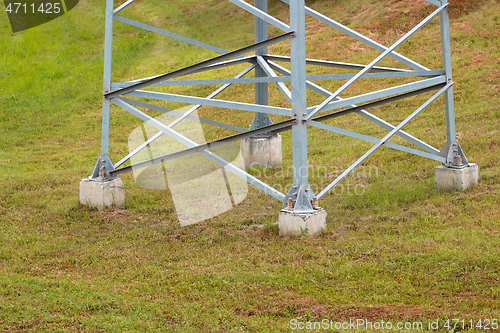 Image of Lower part of a large electric support on a background of green 