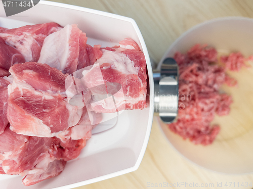 Image of Meat grinder grinds pork meat