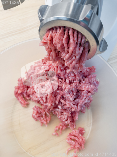 Image of Meat grinder grinds pork meat