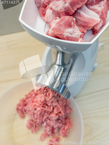 Image of Meat grinder grinds pork meat