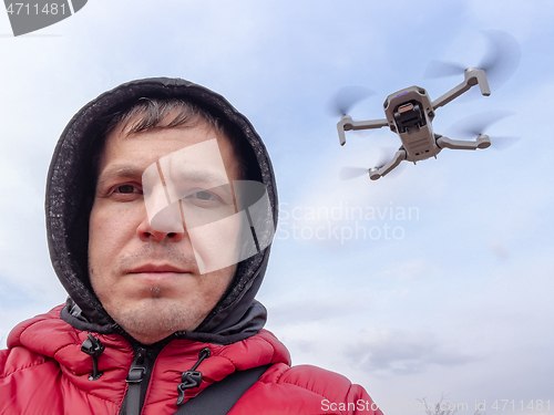 Image of Man controls flying drone