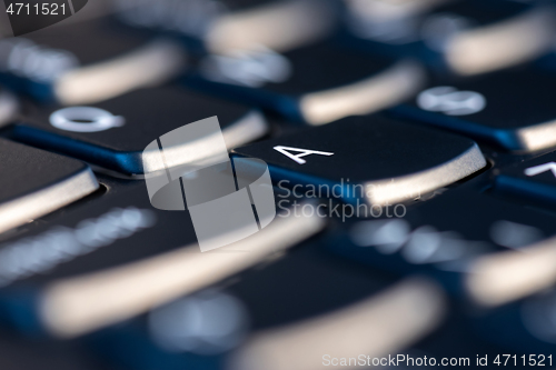 Image of Macro shot of black keyboard focus on A key