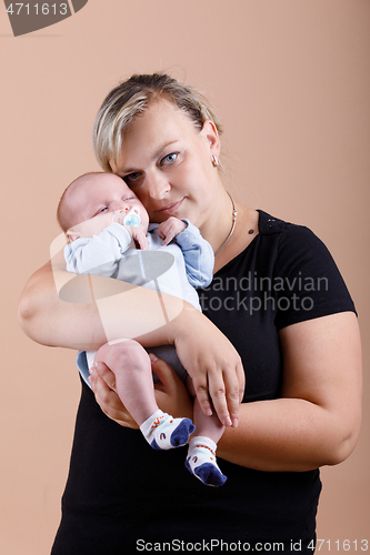 Image of Loving mother embracing her baby