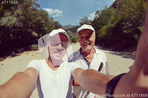 Image of dad and son taking selfie photos