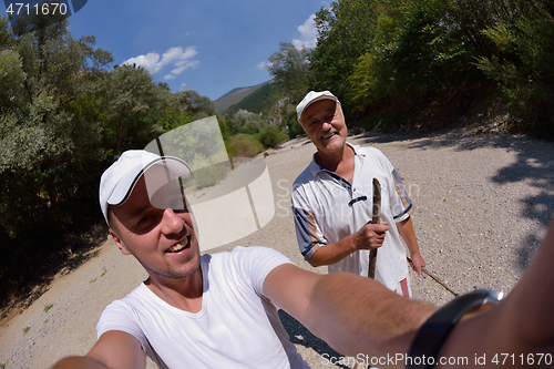 Image of dad and son taking selfie photos