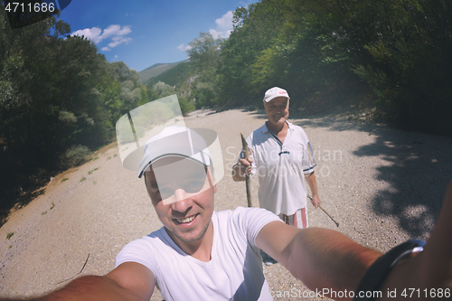 Image of dad and son taking selfie photos