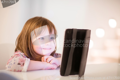 Image of child playing with digital tablet