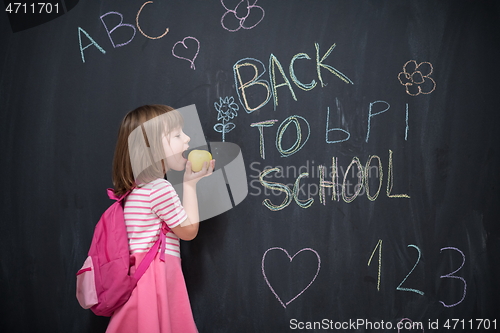 Image of happy child with apple and back to school drawing in background