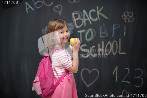 Image of happy child with apple and back to school drawing in background