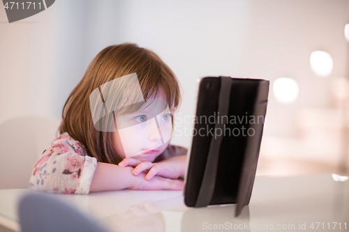 Image of child playing with digital tablet