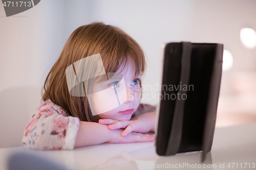 Image of child playing with digital tablet