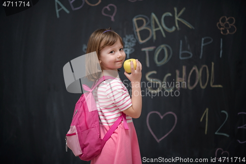 Image of happy child with apple and back to school drawing in background