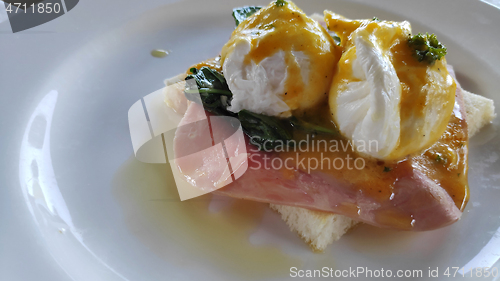 Image of Eggs Benedict and toasted bread with spinach 