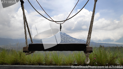 Image of Wooden swing on the rope with view of Batur volcano