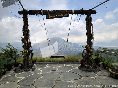 Image of Wooden swing on the rope with view of Batur volcano