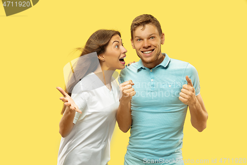 Image of Beautiful couple isolated on yellow studio background